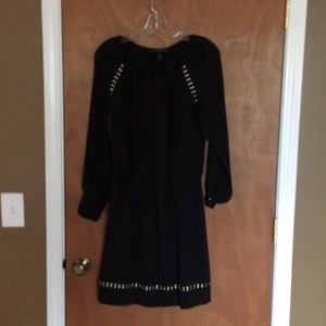 Black blouson dress with silvery gold button trim.